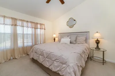 a white bedroom with a large bed and windows at MSW2505 Windsor Hills 3 Bedroom Private Pool Townhome in Orlando