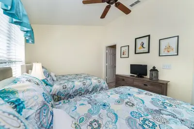 a bedroom with a bed and a flat screen tv at MSW2505 Windsor Hills 3 Bedroom Private Pool Townhome in Orlando