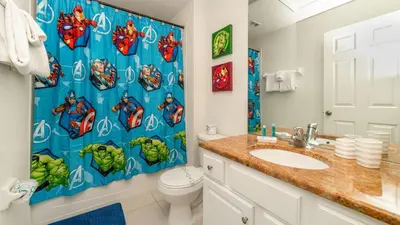 a bathroom with a superhero shower curtain and a toilet at MSW2537 Windsor Hills Resort Vacation Townhome in Orlando