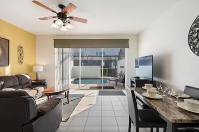 a living room with a couch and a dining room at OP7678 Windsor Hills 3 Bedroom Private Pool Townhome in Orlando