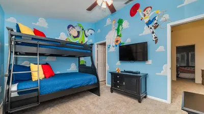 a bedroom with a bunk bed with a blue wall at RS2508 Windsor Hills Resort 3 Bedroom Private Pool Townhome in Orlando