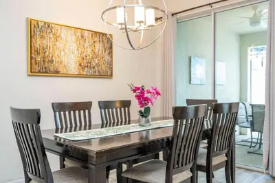 a dining room with a table and chairs at Storey Lake 4 BR with private pool in Kissimmee