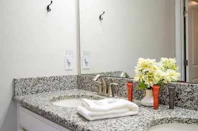 a bathroom counter with a sink and a mirror at Storey Lake 4 BR with private pool in Kissimmee