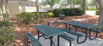a picnic table and benches in a park at Windsor Palm 3 bed Condo in Kissimmee