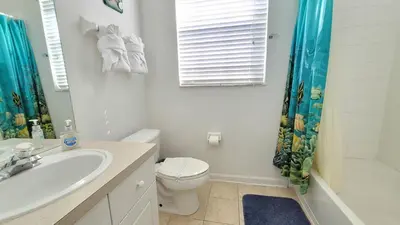 a bathroom with a sink and a toilet and a shower at Windsor Palm 3 bed Condo in Kissimmee