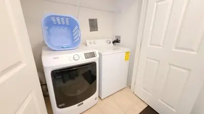 a washing machine with a blue container on top of it at Windsor Palm 3 bed Condo in Kissimmee