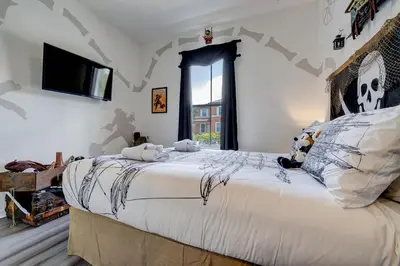 a bedroom with a bed with stuffed animals on it at Disney Family Fun at Regal Oaks in Orlando