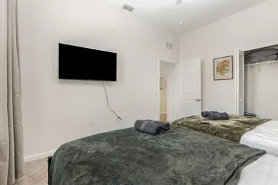 a bedroom with two beds and a flat screen tv at Orlando 2BR Retreat 3 Beds Near Disney&Universal in Orlando