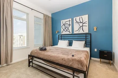a bedroom with a large bed with blue walls at Orlando 2BR Retreat 3 Beds Near Disney&Universal in Orlando