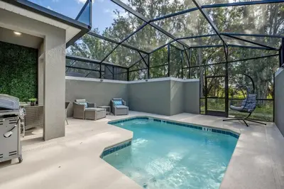 a swimming pool in a house with a glass roof at Casa 5Q c/ Piscina e Temas Disney — Storey Lake in Kissimmee