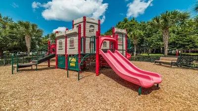 a playground with a red slide in a park at MNL2683 - Windsor Hills Resort Vacation Home - includes resort clubhouse amenity access in Orlando