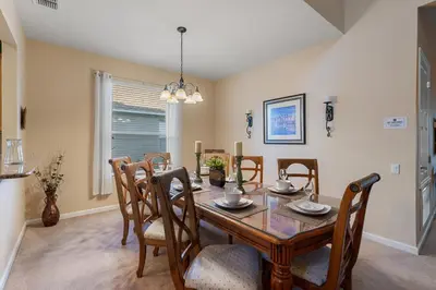 a dining room with a wooden table and chairs at PW2605 Windsor Hills Resort Vacation Home - includes resort clubhouse amenity access in Orlando
