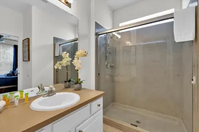 a bathroom with a sink and a glass shower at MNL2702 Windsor Hills Resort Vacation Home in Orlando