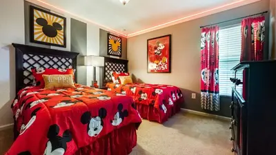 a bedroom with two beds with red comforters at MNL2696 Windsor Hills Resort Vacation Home - includes resort clubhouse amenity access in Orlando