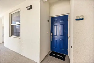 a blue door in the side of a building at 3 Bedrooms 2 Bathrooms Storey Lake 3131-406 in Kissimmee