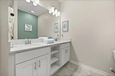 a bathroom with two sinks and a large mirror at 3 Bedrooms 2 Bathrooms Storey Lake 3131-406 in Kissimmee