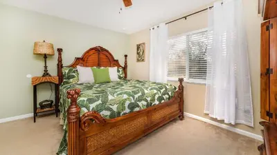 a bedroom with a wooden bed and a window at MNL2696 - Windsor Hills Resort Vacation Home - includes resort clubhouse amenity access in Orlando