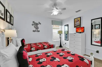 a bedroom with two beds and a red blanket with cows on it at AF2574-Windsor Hills Resort Vacation Home in Orlando