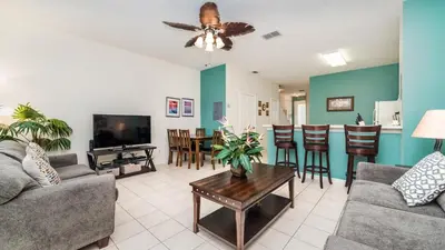 a living room with a couch and a table at PP8114 Windsor Palms Resort Vacation Townhome - includes resort clubhouse amenity access in Kissimmee