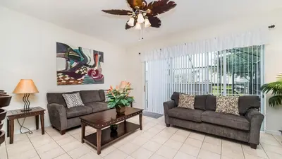 a living room with two couches and a ceiling fan at PP8114 Windsor Palms Resort Vacation Townhome in Kissimmee