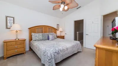 a bedroom with a bed and a ceiling fan at PP8114 Windsor Palms Resort Vacation Townhome in Kissimmee