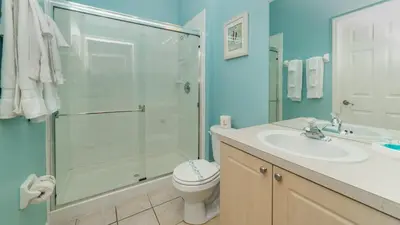 a bathroom with a shower and a toilet and a sink at Windsor Palms Resort in Kissimmee