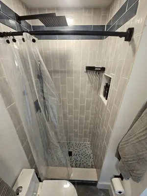 a bathroom with a shower with a toilet at Sanford Suite King Bed Work-Ready Near Beach MCO in Sanford