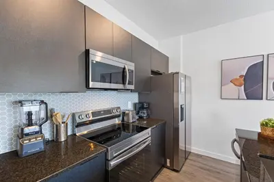 a kitchen with a stove and a microwave at 8740 Enchanted Stay near Disney in Kissimmee