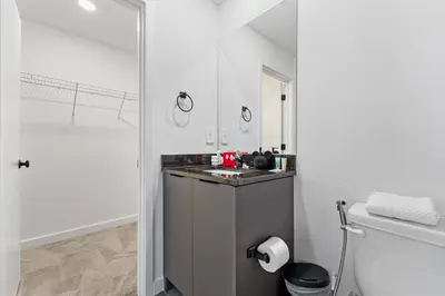 a white bathroom with a sink and a toilet at 8740 Enchanted Stay near Disney in Kissimmee