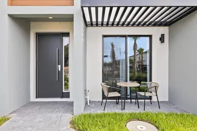 a house with a patio with a table and chairs at 8740 Enchanted Stay near Disney in Kissimmee