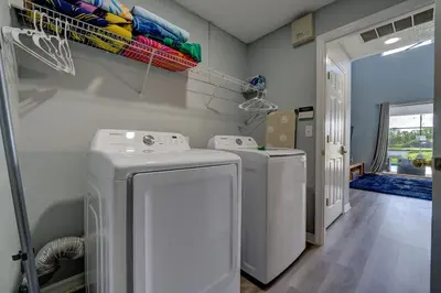 a laundry room with two washing machines in it at Terra Verde Lakeview Escape in Kissimmee