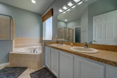 a bathroom with two sinks and a large mirror at Terra Verde Lakeview Escape in Kissimmee