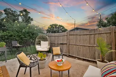 a patio with chairs and tables and a fence at Winter Park Gem 2BR Near Parks 3MI to Downtown in Orlando