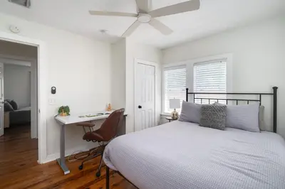 a bedroom with a bed and a desk and a ceiling fan at Winter Park Gem 2BR Near Parks 3MI to Downtown in Orlando