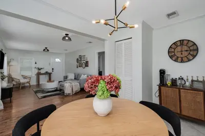 a vase of flowers on a table in a living room at Winter Park Gem 2BR Near Parks 3MI to Downtown in Orlando