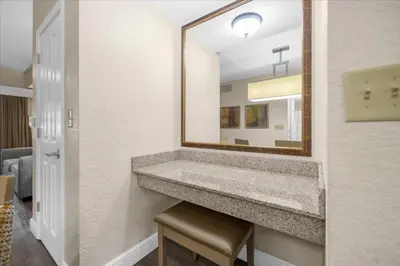 a bathroom with a sink and a mirror at Resort Style Condo 4 miles from Disney in Orlando