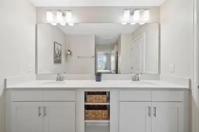 a bathroom with two sinks and a large mirror at 3141 Paradox Circle 101 in Kissimmee