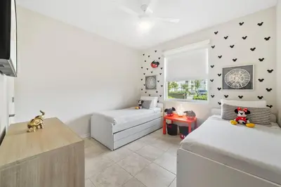 a bedroom with two beds and a window at 3141 Paradox Circle 101 in Kissimmee