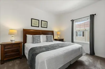 a bedroom with a large bed and a window at 4 Bedrooms 3 Bathrooms Lucaya Village 23-108 in Kissimmee