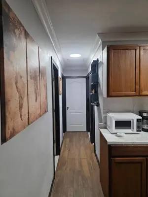 a small kitchen with a microwave on a counter at Epic Universal park neigbour 1500 feet in Orlando