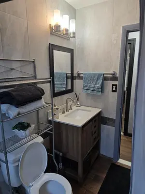 a bathroom with a sink and a toilet and a mirror at Epic Universal park neigbour 1500 feet in Orlando