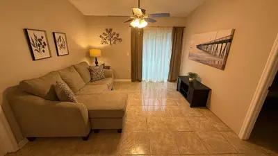 a living room with a couch and a ceiling fan at J10 Private Room with Smart TV Near Everything in Orlando