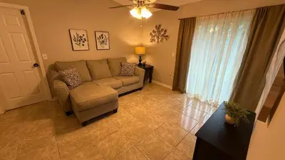 a living room with a couch and a window at J10 Private Room with Smart TV Near Everything in Orlando