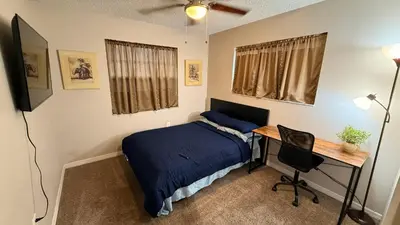 a bedroom with a bed and a desk and a desk at K11 Private Room with Smart TV Near Everything in Orlando