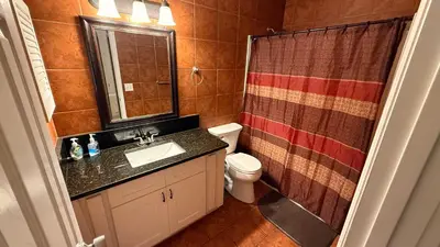 a bathroom with a sink and a toilet and a shower at K11 Private Room with Smart TV Near Everything in Orlando