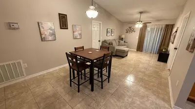 a living room with a table and a couch at K11 Private Room with Smart TV Near Everything in Orlando