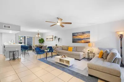 a living room with a couch and a table at Magic & Comfort in the Palms!Near Disney-Universal in Kissimmee