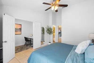 a bedroom with a blue bed and a ceiling fan at Magic & Comfort in the Palms!Near Disney-Universal in Kissimmee