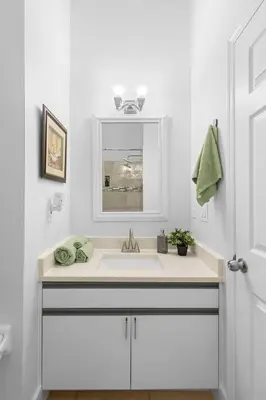 a white bathroom with a sink and a mirror at Magic & Comfort in the Palms!Near Disney-Universal in Kissimmee