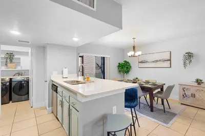 a kitchen and dining room with a table and a counter at Magic & Comfort in the Palms!Near Disney-Universal in Kissimmee